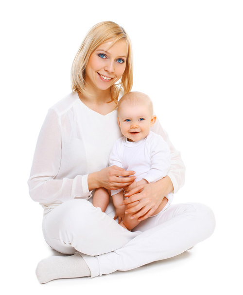 Happy smiling mother with baby sitting together on white backgro - Foto, immagini