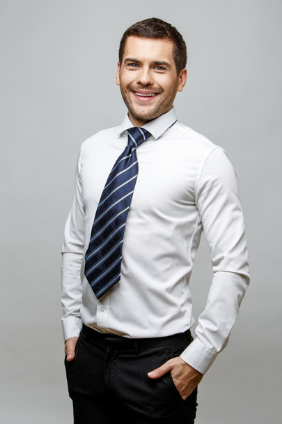 Handsome stylish businessman on grey background - Fotografie, Obrázek