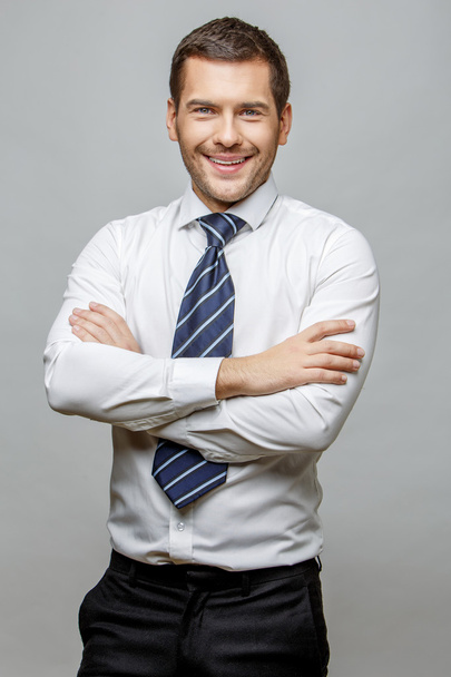 Handsome stylish businessman on grey background - Photo, Image