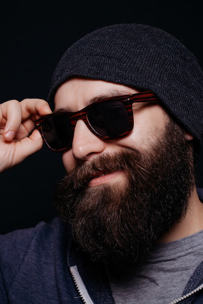 Handsome male big beard in glasses and hat - 写真・画像