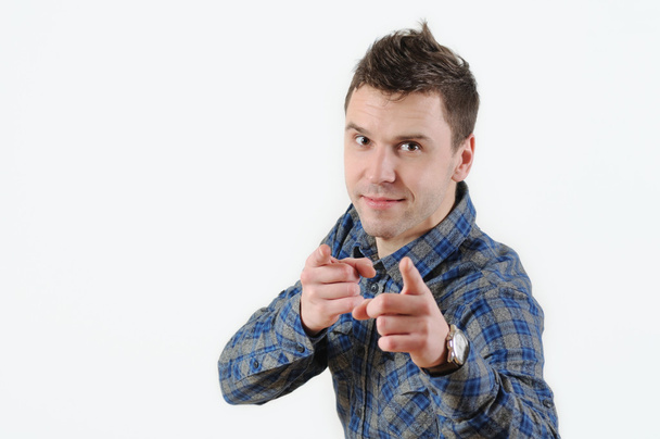 Portrait handsome young smiling man giving thumbs up pointing fingers at camera - Photo, Image
