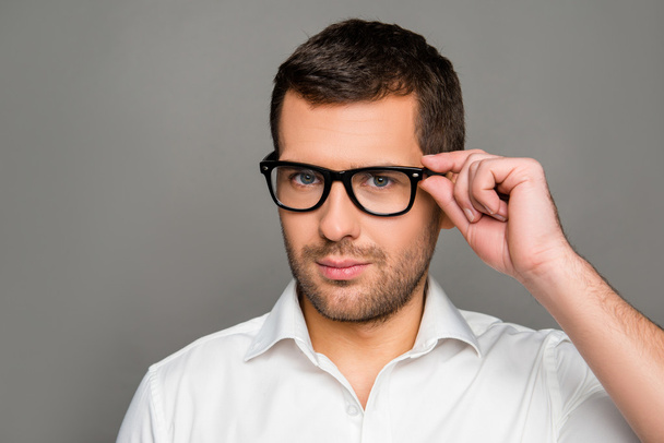Smart man  touching his glasses - Fotografie, Obrázek