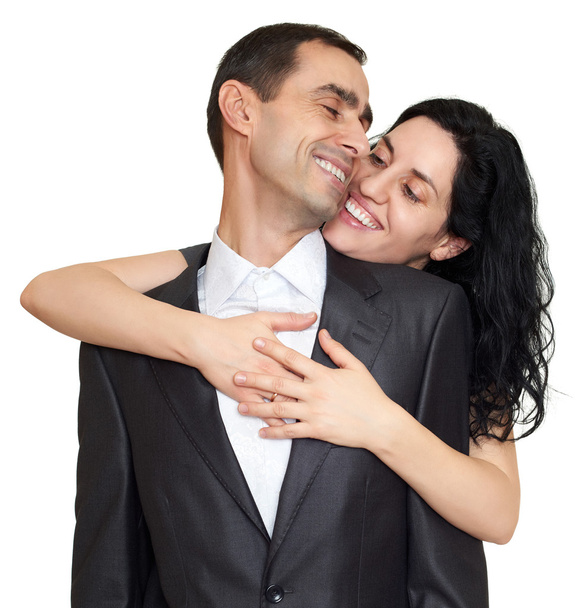 Couple embrace, studio portrait on white. Dressed in black suit. - Photo, Image