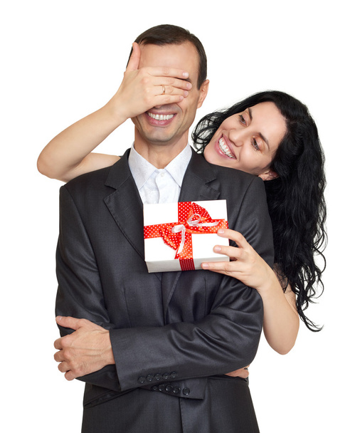 Couple with gift box, studio portrait on white. Woman close man eyes. Dressed in black suit. - Foto, Bild
