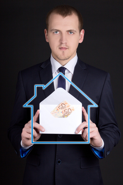 mortgage concept - business man holding envelope with money - Valokuva, kuva