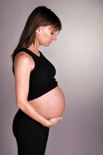 Pregnant girl in studio  - Fotó, kép