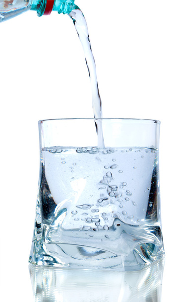 Puring fresh water on glass on white background - Foto, imagen