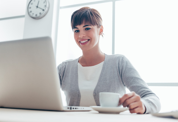 businesswoman sitting at office desk - Photo, image