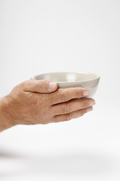 Hungry man holding empty bowl - Zdjęcie, obraz