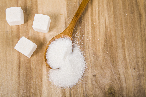 Sugar in a wooden spoon   - Photo, Image