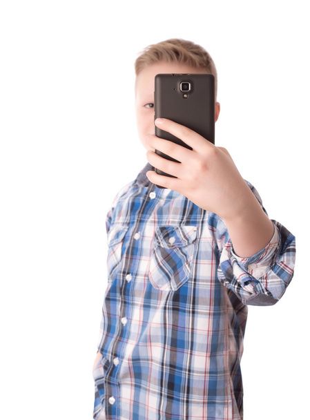 Child take a photo with his phone isolated on white - Foto, afbeelding