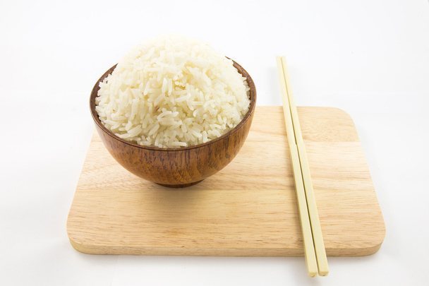 Bowl of rice and chopsticks on wooden isolated on white - Foto, Bild