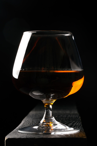 Glass of cognac on the black table - Foto, immagini
