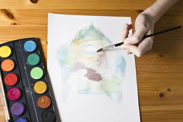 The artist paints a picture Wolf using brush and watercolor colorful painting set. - Photo, Image