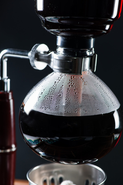 Puer tea in the siphon, shallow DOF, on black background - Foto, afbeelding