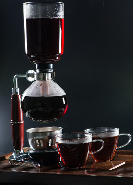 Puer tea in the siphon, shallow DOF, on black background - Foto, Bild