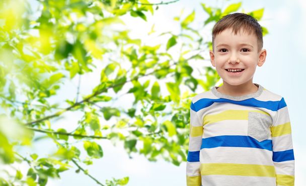smiling little boy over green natural background - Foto, Imagen