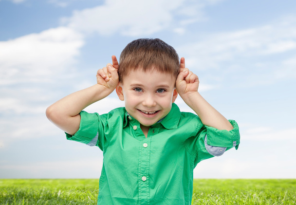 happy little boy having fun and making horns - Photo, Image