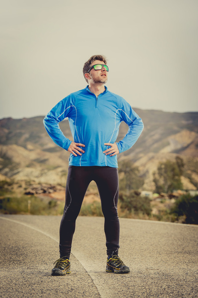 sport man runner posing on dry desert landscape in fitness healthy lifestyle - Photo, Image