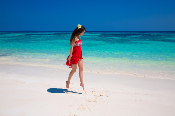 Enjoy life. Beautiful girl jumping running on exotic beach with  - Foto, immagini