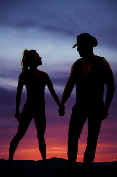 silhouette of a woman stand hold hands with cowboy - Fotó, kép