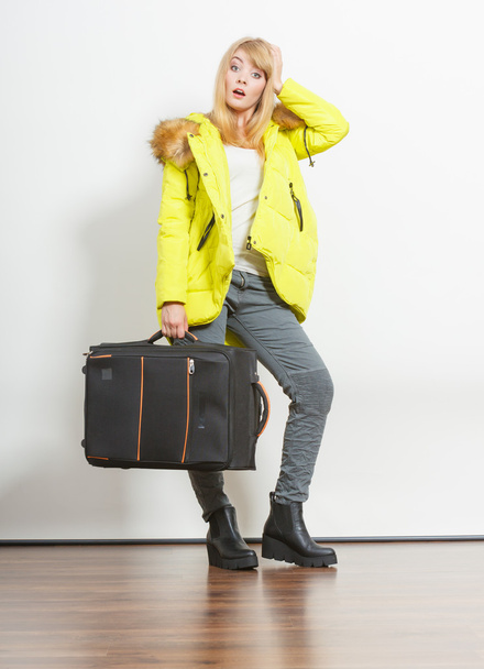 Young woman in warm jacket with suitcase. - Fotoğraf, Görsel