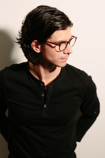 Young man in a black sweater and glasses. - Φωτογραφία, εικόνα