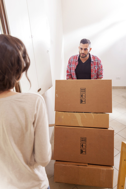 young couple carrying the boxes in new house - Photo, Image