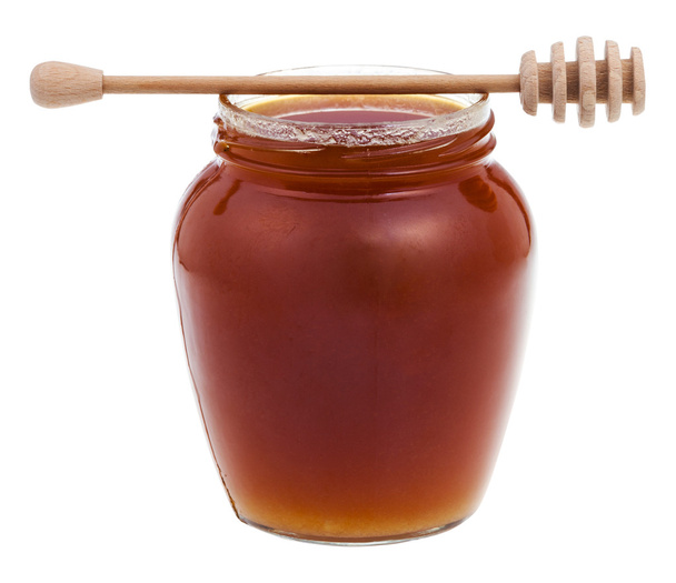 вид збоку скляна банка з медом та дерев'яною паличкою
 - Фото, зображення