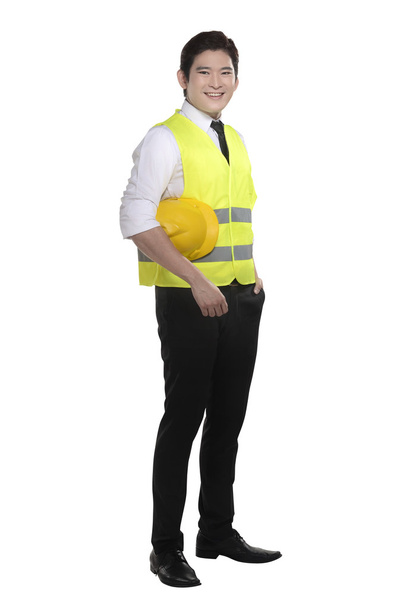 працівник носить жилет безпеки і шолом
 - Фото, зображення