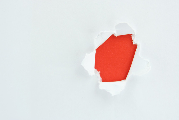 Ripped white paper against a red background - 写真・画像