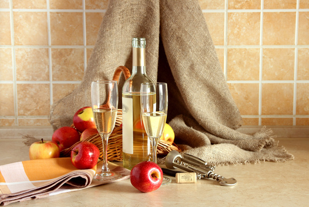 Glasses of wine and a basket of apples. - Fotografie, Obrázek
