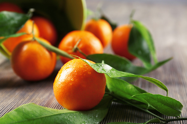 Peeled fresh mandarin on wooden table, closeup - Фото, изображение