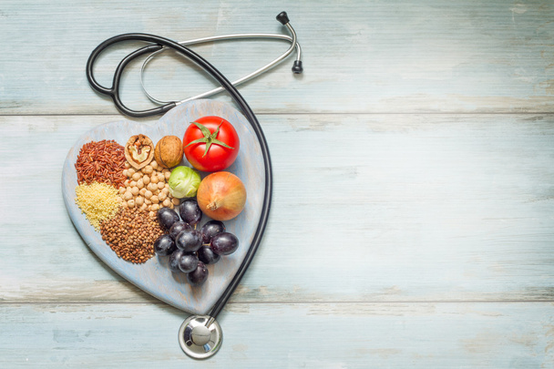 Healthy lifestyle and healthcare concept with food, heart and stethoscope - Fotoğraf, Görsel