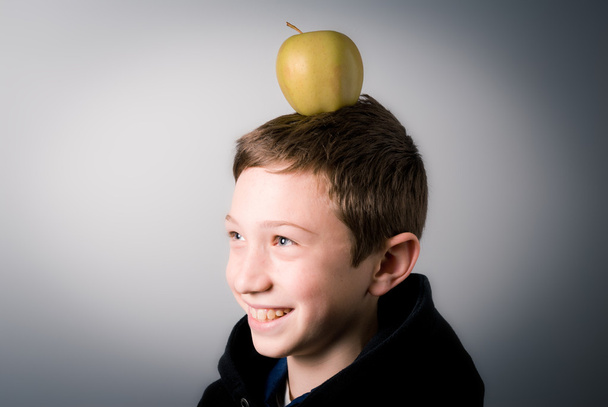 Boy with a green apple on his head - Fotoğraf, Görsel