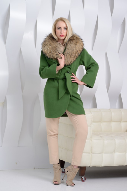 Girl in studio posing at coat - Foto, imagen