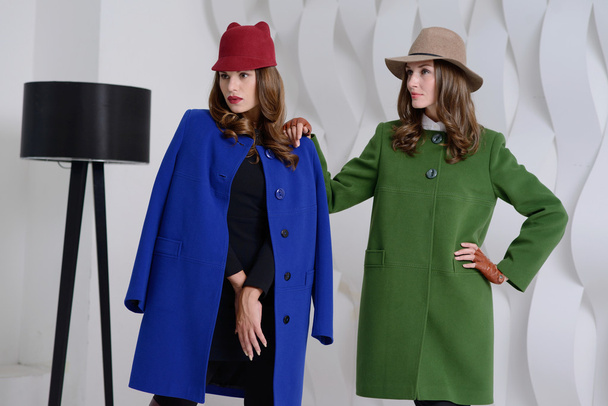 Girls in studio posing at coats - Fotografie, Obrázek