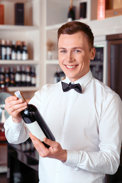 Professional sommelier holding wine bottle - Zdjęcie, obraz
