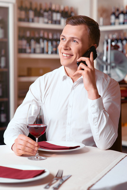 Pleasant man sitting at the table in restaurant - Foto, immagini
