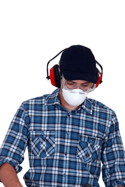 Craftsman wearing protection mask, earphones and glasses - Valokuva, kuva