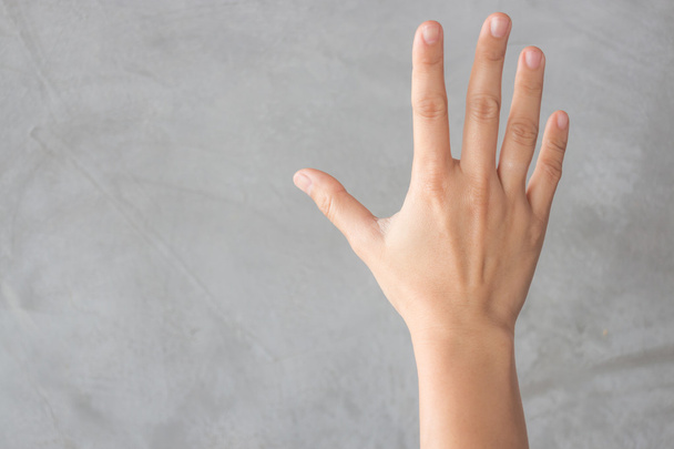 Hand action gesture on grey background - Фото, изображение