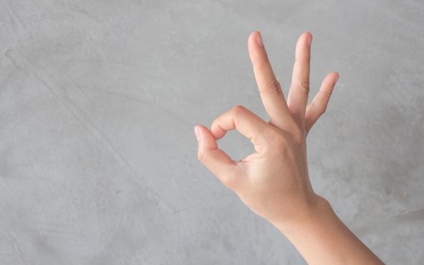 Hand action gesture on grey background - Foto, afbeelding