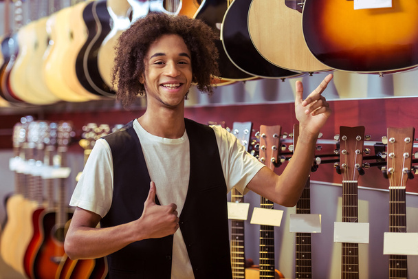 Man in musical shop - Photo, Image