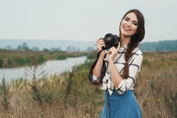 pretty playful country lady posing with camera against pond - Zdjęcie, obraz