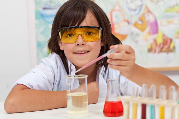 Young pupil conducting a simple chemical experiment - Fotó, kép
