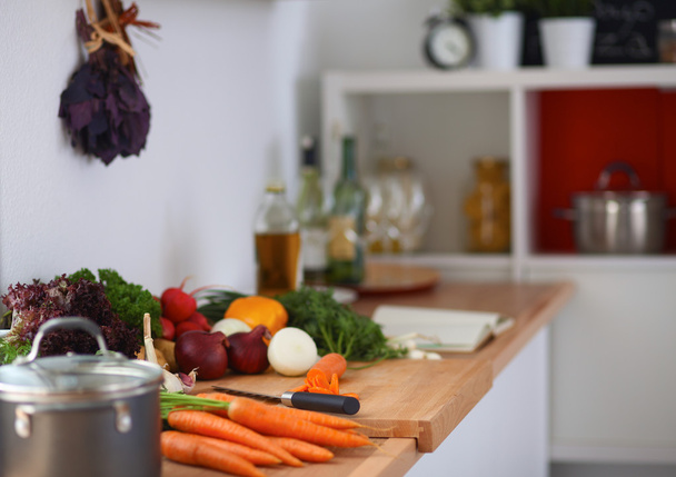 Vegetables on the desk in a kitchen - Фото, зображення