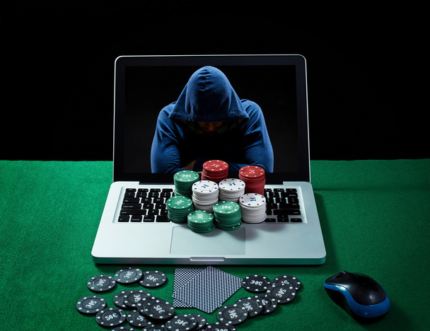 Green table with casino chips and cards on notebook - 写真・画像