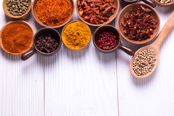 spices and herbs on wooden table. - 写真・画像
