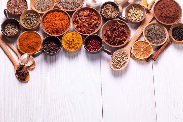 spices and herbs on wooden table. - 写真・画像