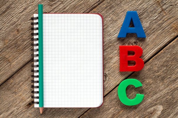 Notebook with pencil and ABC letters - Фото, изображение
